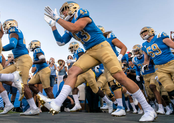 UCLA players take the field at the Rose Bowl before upsetting LSU.